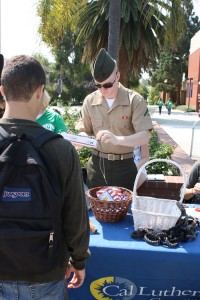 Saluting Service: Cpl. Lance Skidmore helps a CLU student make a paracord bracelet for a soldier.   Photo by Stine Norum - Staff Photographer