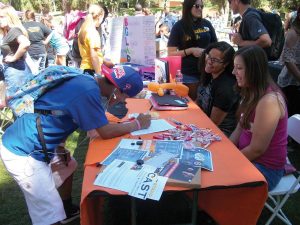 Clubs on parade: Freshman Ryan Murata signs up for Not For Sale, which works to fight human trafficking. Photo by Rebecca Bomfin- Staff Photographer 