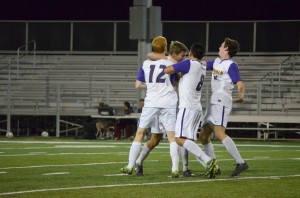 In the knick of time: Alex Wardle is mauled by teammates Bryce Truver (12), David Lee (8) and Henry Breheny (right) after scoring the game-tying goal on Oct. 5 against Pomona-Pitzer at William Rolland Stadium. Photo by Arianna Cook - Staff Photographer 