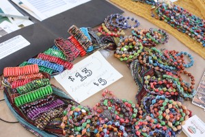 BeadForLife: Junior Berlin Galvan will sell beaded bracelets made by Ugandan women at the World Trade Fair on Nov. 14.   Photo by  Stine Norum- Staff Photographer