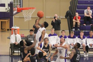 Living above the rim: Arik Smith makes a contested layup on Feb. 19 against Whittier. Smith led the team with 19 points in the 68-56 victory. Photo by Courtney Nunez - Staff Photographer