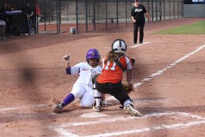 Making a statement:  Ryanna Moura slides safely into home. Moura went 2-2 in game one. 