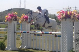 Jump around: Anna Ishiyama competing in the 30-meter class with the horse named Estelle. Photo courtesy of Anna Ishiyama