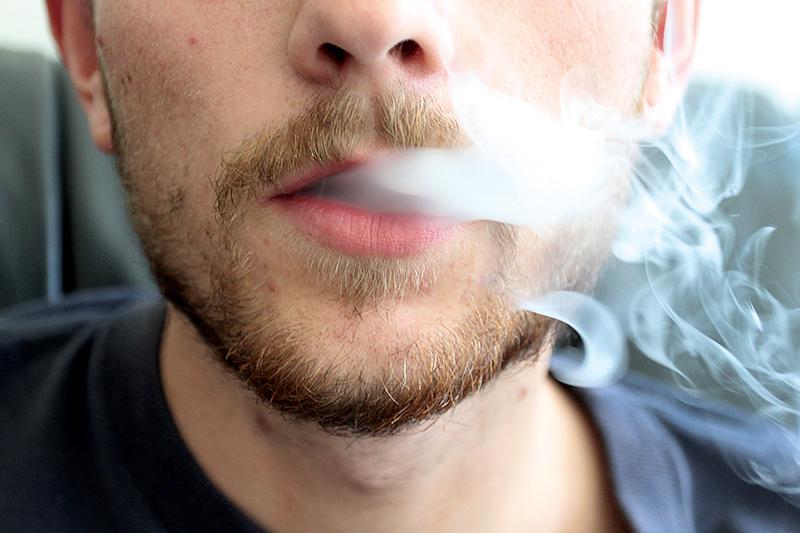 Smoke Signals: Junior Henrik Simonsen exhales water vapor from an electronic cigarette. 
Photo by Haakon Asker-Staff Photographer