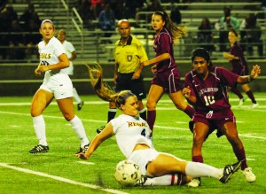 Combat on the pitch: (Top) Junior defender Mallory Carcich slide tackles the ball away from a Redlands opponent. (Right) Junior defender Jenna Malinowski heads the ball to a teammate. (Bottom) Senior midfielder Alli Calabrese battles to maintain possession in Wednesday night’s game.  Photos by Andrea Whisler - Staff Photographer