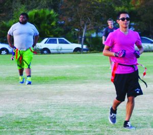 Save the TDs: Marcell Lee (left), Justin Fallon (front) and Alastair Moody (back right) playing in the flag football games on Oct. 16 on Mount Clef Field. Photo by Charlotte Luisa - Staff Photographer
