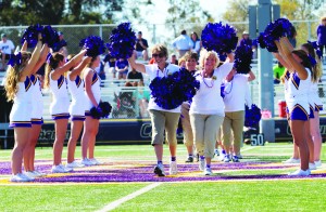 Go Cal Lutheran: Cheerleaders from the 1966 graduating class ran through an arch formed by the current Cal Lutheran  cheerleaders during their halftime performance. Photo by Genesis Rodriguez - Staff Photographer