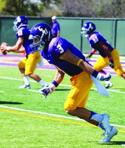 Fine tuning technique: Junior wide receiver Sean Bellotti practicing his route running during pregame warmups. Bellotti caught two touchdowns on Saturday. Photos by Genesis Rodriguez - Staff Photographer