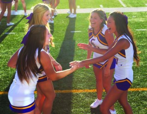 Cheering for CLU: (Left) Cal Lutheran cheerleaders Kendra Lewin (front left), Lauran Minark (back left), Mariah Gonzalez (back right), and Valarie Pham (front right) were excited for their performance. Photos by Genesis Rodriguez - Staff Photographer
