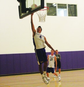 Junior forward Guy Lynott goes up for a dunk during practice. Photos by Paulyn Baens - Staff Photographer