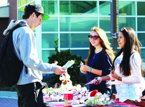 Getting Crafty: Juniors, Ashley Lomelin and Monica Louis are excited to have their first sale to promote their club at Reindeer Hot Cocoa Fundraiser to senior Connor Treacy. Photo by Tina Abbaszadeh - Staff Photographer