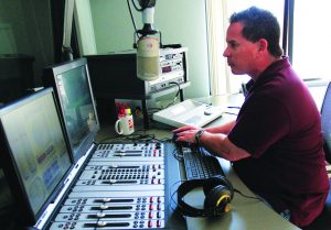 On the air: Lance Orozco, the news director at KCLU, edits together his voice and other audio clips for his news stories that will play during afternoon drivetime. 