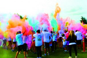Flying colors: Participants of the 5K Color Dash threw paint in the air creating a cloud of colors.