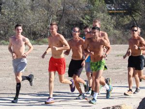 Senior Garrett Baker (second from left) runs alongside teammates.  Baker has found other ways to lead his team while nursing an injury. Photo by Brady Mickelson - Staff Photographer