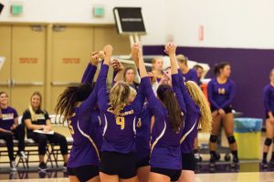 Dominance: The Regals celebrate after scoring a point against Providence Christian College. The Regals went 4-0 in the Cal Lu Fornia Invitational and only dropped one set in the four matches. 