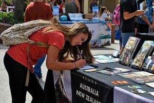 Pursuing travel: Freshman Cassidy Hiltibran signing up for information about studying abroad in Australia. Cal lutheran is currently offering study abroad programs with partner-affiliates in over 70 different countries.  Photo by Karina Hernandez  - Staff Photographer