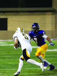 Friederichsen led the Kingsmen to a comeback victory in their season opener. (Right) Junior defensive back Logan Sanders and the Kingsmen defense held Pacific Lutheran scoreless in the second half. Photo by PK Duncan - Staff Photographer