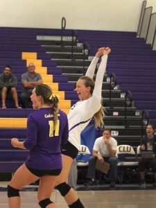 Volleyball captain Allie Eason cheers after a set win with co-captain Nikki Tetherow. 