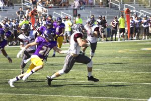 Senior Trever Wood attempts to bring down a Redlands player in the Kingsmen’s 13-10 Homecoming loss. Photo by Brady Mickelson - Staff Photographer