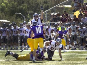 Sophomore quarterback Adam Friederichsen (10) looks to complete a pass to target Sean Bellotti (3). Friederichsen was 11-19 for 142 yards in the loss to the Bulldogs.  Photo by Brady Mickelson - Staff Photographer