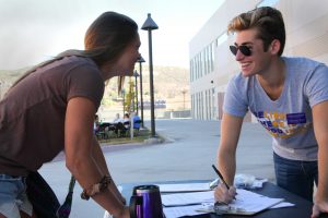 Junior Adam Santa Cruz registers Senior Liz Lawrence for service day at Cal Lutheran. Photo by PK Duncan - Staff Photographer