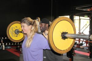 Sloane Thomas lifts weights with a trainer at The Stadium. Photo by Andrew Turley - Staff Photographer