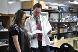 Junior Livia Bowman and her brother, senior Trevor Bowman going over some last minute details for their UFO Halloween Party.