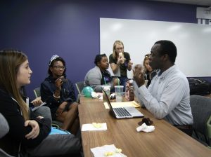 Senior Tetteh Canacoo talks to his committee about possible upcoming events for the spring semester.  