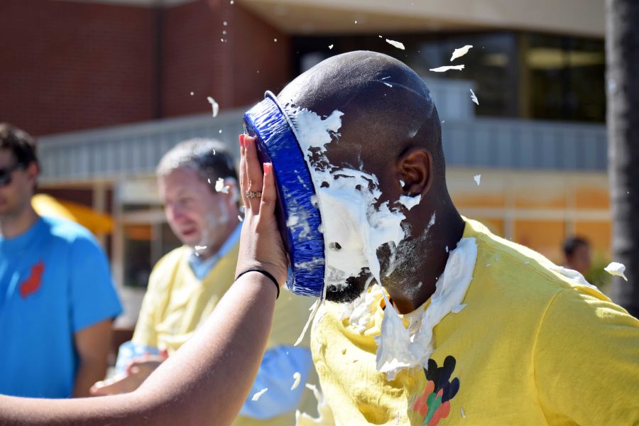Student Involvement Coordinator Ri'chard Caldwell willingly is given a splattering pie to the face. 
Photos by Roman Valenzuela - Staff Photographer