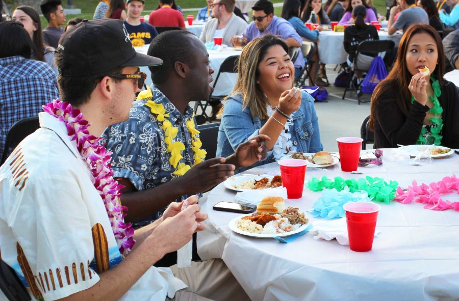 Students Tetteh Canacoo, Paulyn Baens and Trianna Owens enjoy food served at the Hawaiian club's annual Luau. 
Photo by Jackie Rodriguez - Staff Photographer