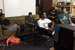 Cramped spaces: The residents of South 9206 gather in their living room to play some video games and hang out. Back: Andrew Vasquez, Andres Hooper, Ryan Muñoz. Front: Cortez Espinoza, Andrew Valenzuela