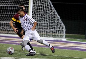 Senior Zach Torres defends Cal Lutheran’s goal against a CMS forward at senior night on Monday. Photo Credit--Annette Sousa Staff Photographer