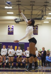 Soaring above: Hope Stewart is seen flying high about to send the ball over the net for a kill. Photo Credit--Eric Duchanin Staff Photographer
