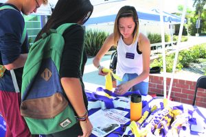 Puppy Love: Ana Sofia Campos gets a new tug toy ready to give a student to complete. Photos by Kaelani Medina- Staff Photographer 