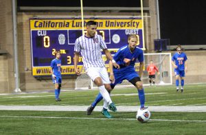 Shooting by: Oxnard transfer Diego Ortega looks to pass the ball away from the Sagehens defense so the Kingsmen can keep control of the ball. Photo Credit--Morgan Mantilla Staff Photographer