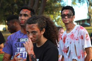 Marathon of the living dead: Sophomore Ramsey Khader, sophomore Alison Yurk and senior Keanu Quick get into their zombie characters complete with bloody make-up prior to the run.