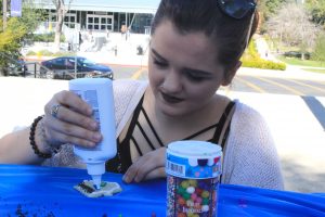 Home Decor: Katie Shearer decorates a cookie shaped like a house on the Spine during an event to promote the upcoming Habitat for Humanity build day on Feb. 25 through the Community Service Center.  Photo by Amanda Souza- Staff Photographer 