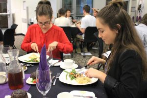 (L to R) Andrea Teodorescu and Patty Teodorescu. Sisters Andrea Teodorescu and Patty Teodorescu practice proper utensil usage and dining skills they learned throughout the dinner. Photos by Amanda Souza - Staff Photographer 