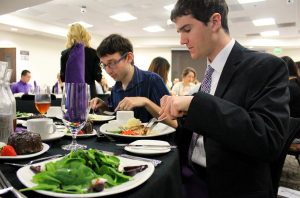 (L to R) Andrew Crago and Grant Bagne. Crago and Bagne practice proper dining etiquette as they eat the second course of their three course meals.  Photos by Amanda Souza - Staff Photographer 