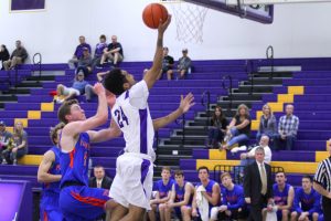 Push past: Senior (24) Wolfgang Wood successfully goes up for a layup to hold off the Sagehens in a two-point victory. Photo by Mary Crocker--Staff Photographer