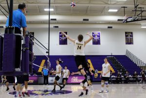 Flying high: 14 Mason Mercer goes up for a kill against Hope International Feb. 16. Photo Credit--Adrian Francis Staff Photographer