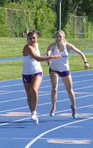 Passing by: Junior sprinter and jumper Anna Schlosser competed in five events for the Regals and acheived a new personal record in high jump clearing five feet. Photo by Tracy Olson--Sports Information Director