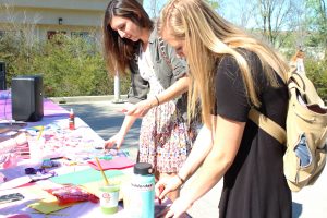 Cat Olney and Eliza Weber stop by the Her Campus Valentine gram table Tuesday Feb. 14 for Valentine’s Day.  