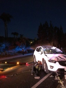 The white Mazda CX-5 after it has been righted by tow truck operators. Photo by Dakota Allen, Staff Writer