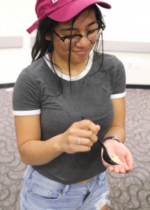 Every grain matters: Amanda Oyao eats rice from the palm of her hand as part of the low economic class at the Hunger Banquet.