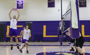 Spiked: (3) Nick Shoemate goes to set (11) Justin Dietrich to smash a kill on the opponent’s court, helping the Kingsmen win 2 out of 3. Photo by Adrian Francis--Staff Photographer