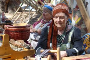 Ancient clothing: Judith Vinje uses an inkle loom to weave cloth decorations that ancient Vikings used to swaddle infants and embellish clothing. 