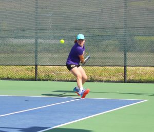 Senior salute: Senior Emily Werman with the help of sophomore Christie Kurdys were victorious in their doubles match 8-6, notching a point in the win for the Regals. Photo by Adrian Francis--Staff Photographer