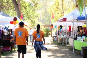 Pumpkinpalooza attendees on Saturday, Oct. 7 walk by tables with vendors. Photo by Inga Parkel- Photojournalist