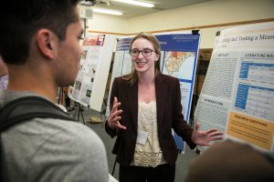 Cal Lutheran junior Laura Willits discusses her research project with attendees of the Student Research Symposium. Photo provided by Brian Stetham